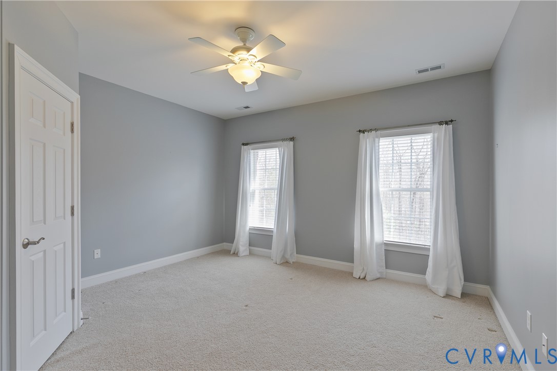 630 Cross Ridge Lane Manakin-Sabot, VA 23103 - Photo 36 of 48 an empty room with windows and chandelier fan