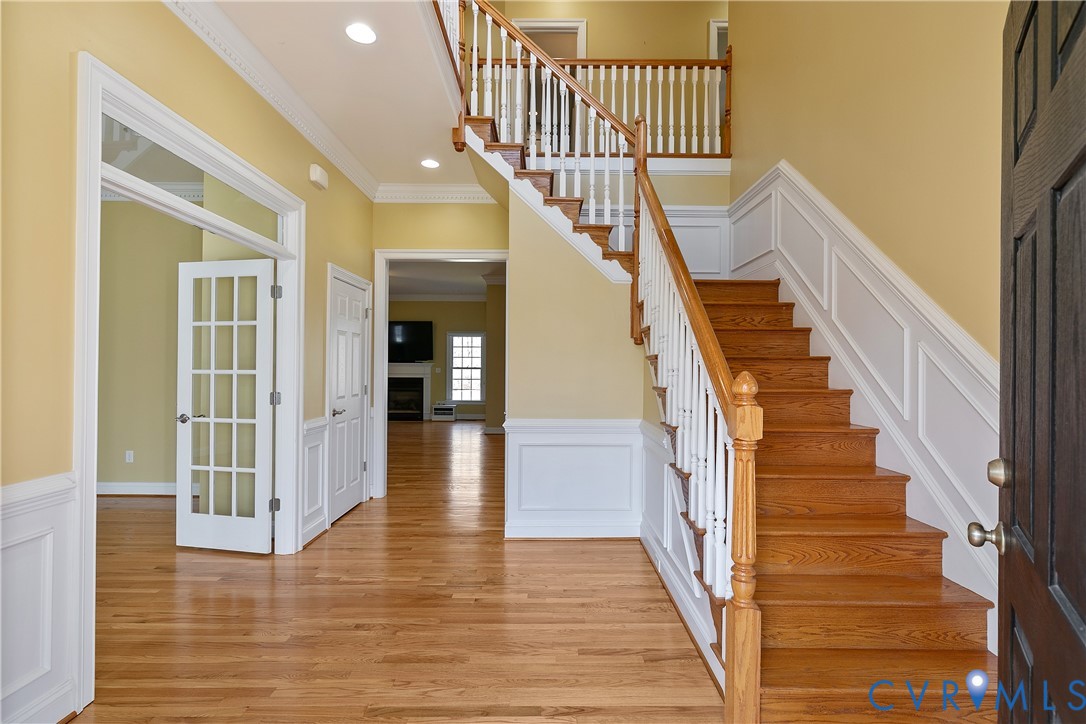 630 Cross Ridge Lane Manakin-Sabot, VA 23103 - Photo 6 of 48 a view of staircase with lots of frames on wall and wooden floor