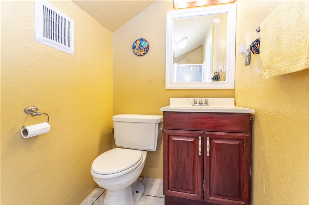 9021 Oneida Avenue Sun Valley, CA 91352 - Photo 18 of 36 a bathroom with a toilet a sink and mirror