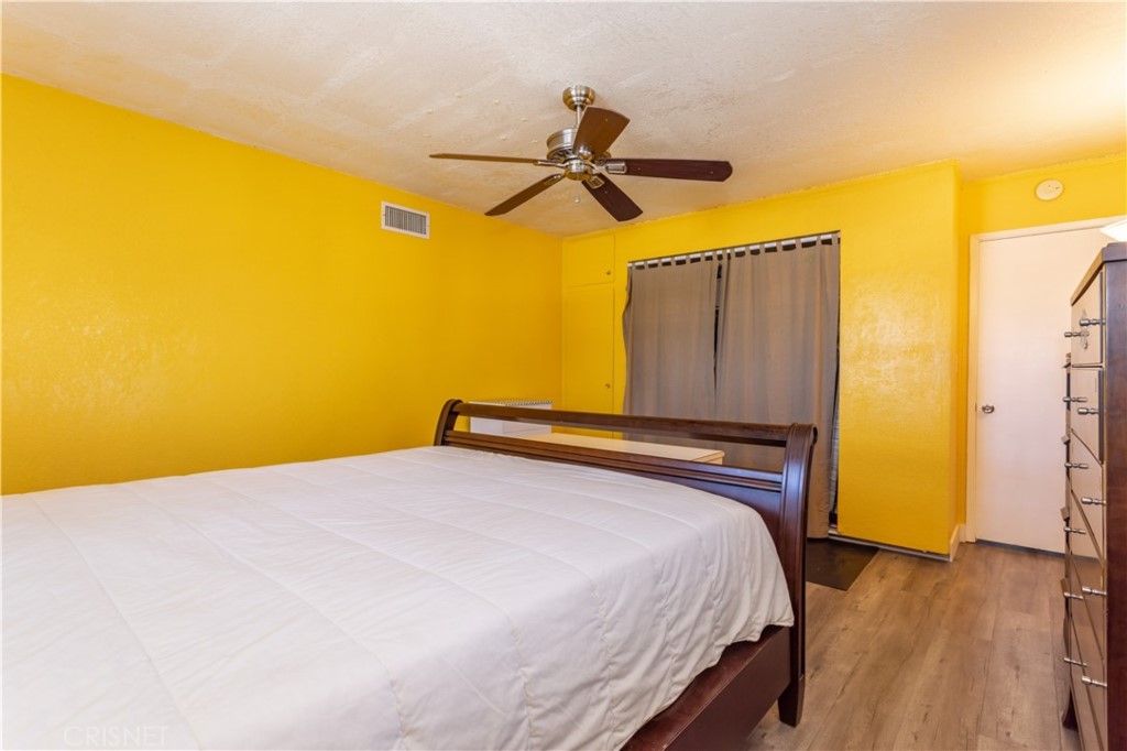 9021 Oneida Avenue Sun Valley, CA 91352 - Photo 20 of 36 a bedroom with a bed and wooden floor