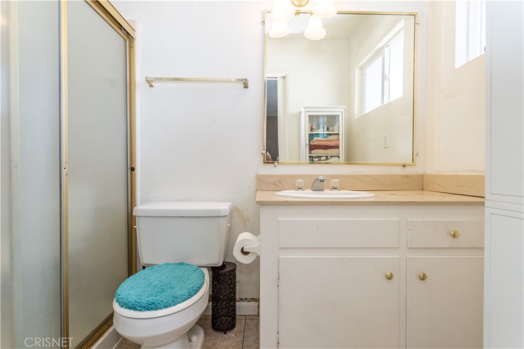 9021 Oneida Avenue Sun Valley, CA 91352 - Photo 4 of 36 a bathroom with a granite countertop toilet and a sink