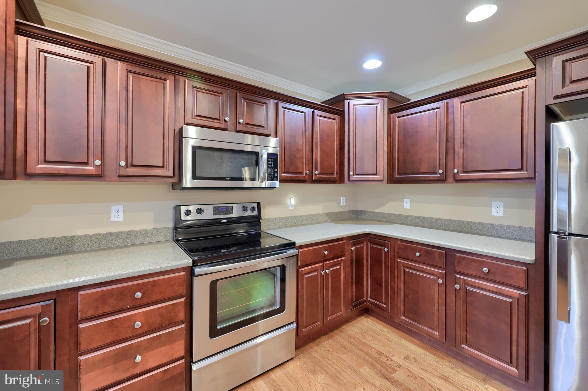 120 Baneberry Lane Lititz, PA 17543 - Photo 17 of 36 a kitchen with wooden cabinets stainless steel appliances and a sink