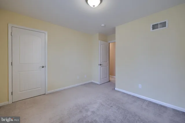a spacious bathroom with a double vanity sink toilet and a mirror
