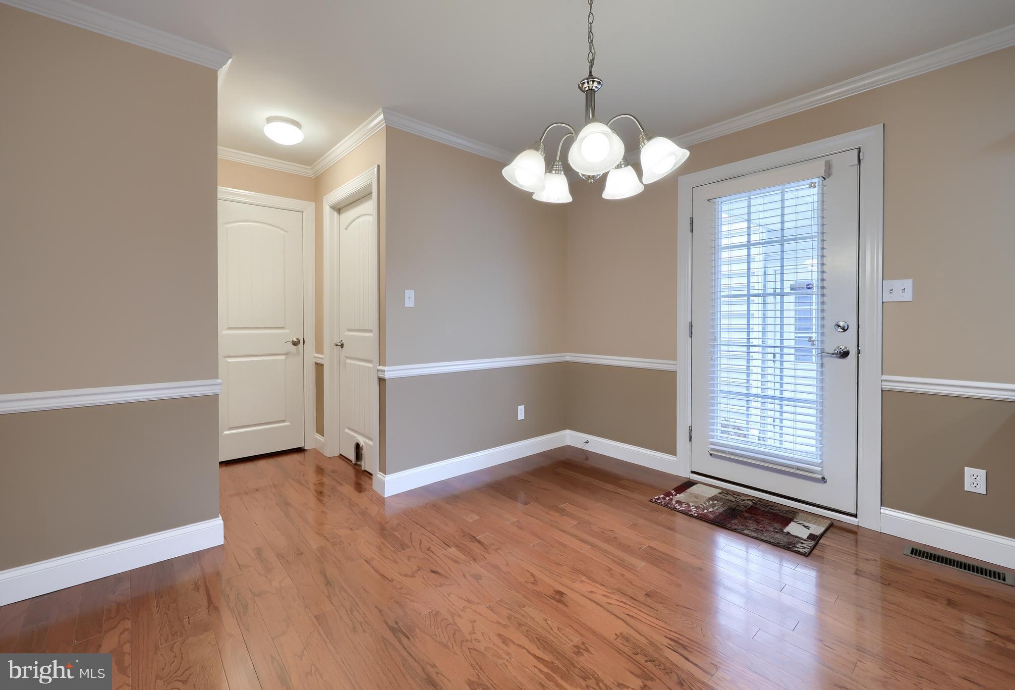 120 Baneberry Lane Lititz, PA 17543 - Photo 9 of 36 an empty room with wooden floor and windows