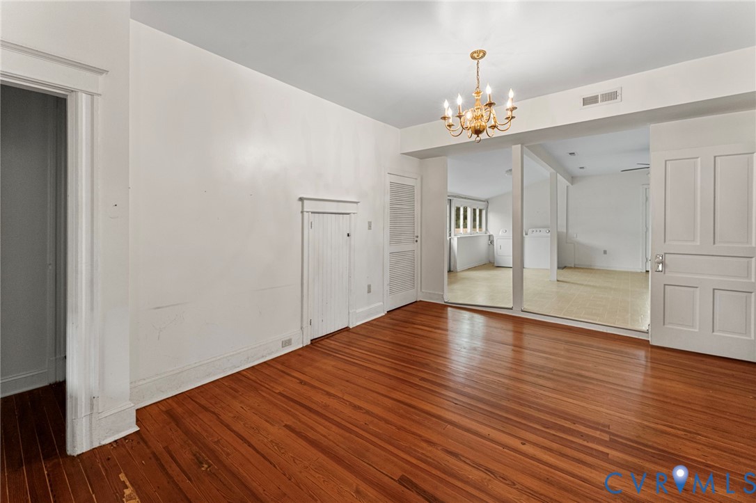 4516 Oldhams Road Hague, VA 22469 - Photo 11 of 23 a view of an empty room with wooden floor and a kitchen