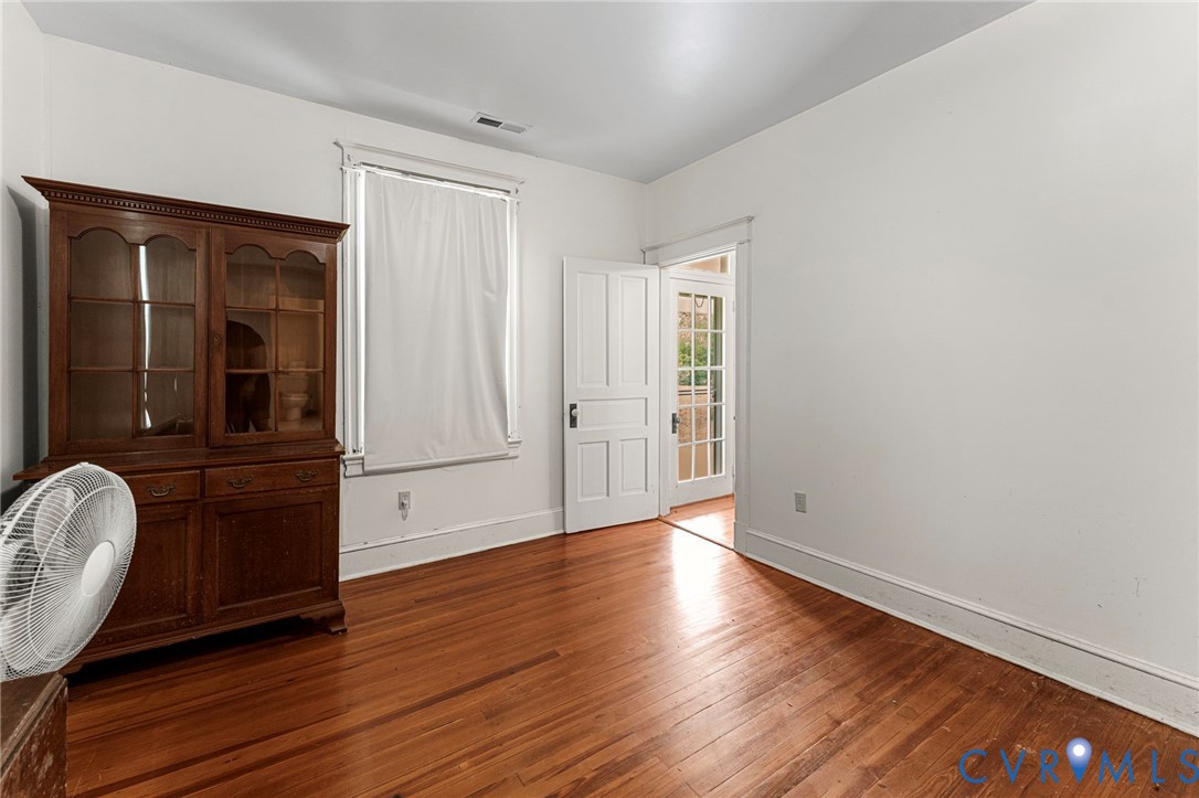 4516 Oldhams Road Hague, VA 22469 - Photo 13 of 23 an empty room with wooden floor and windows