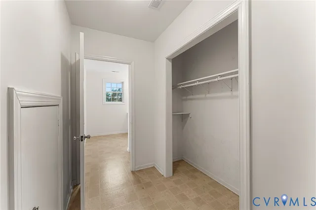 a view of bathroom with a toilet sink and mirror