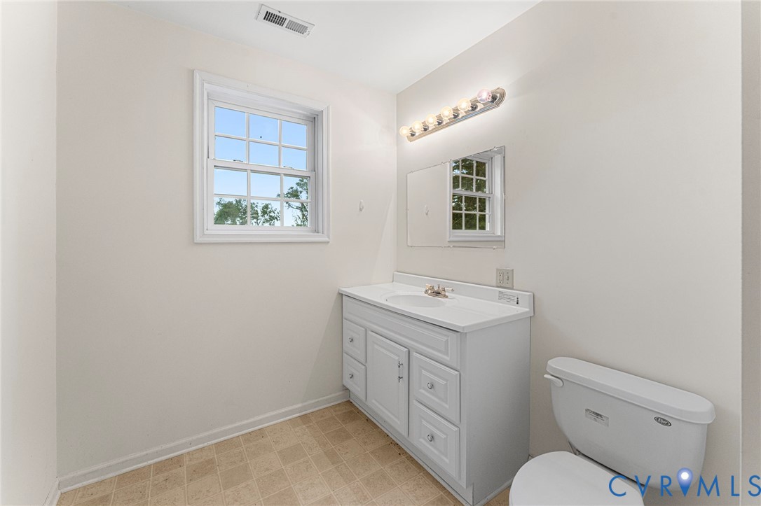 4516 Oldhams Road Hague, VA 22469 - Photo 20 of 23 a view of bathroom with a toilet sink and mirror