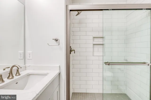 a bathroom with a sink and shower