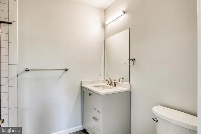 a bathroom with a sink a toilet and mirror