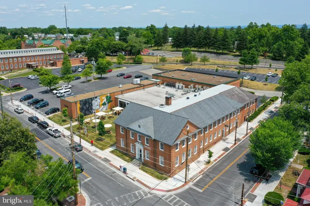 an aerial view of a house with a garden and lake view
