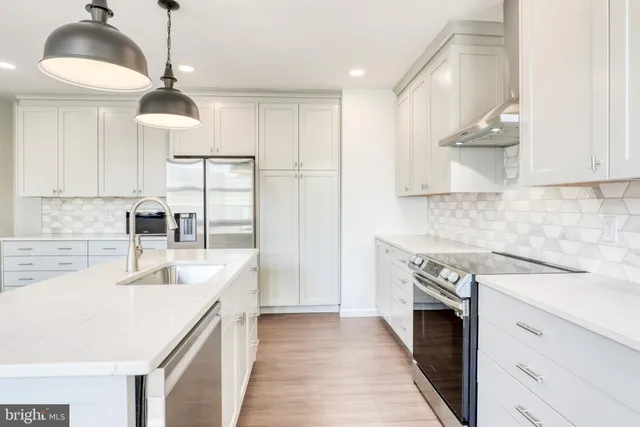 a kitchen with a stove cabinets and a sink