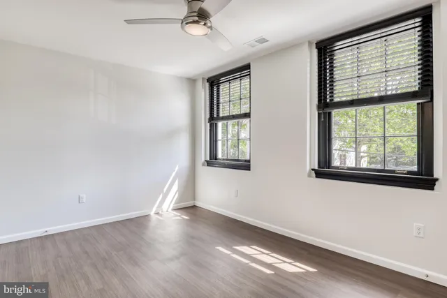 wooden floor in an empty room with a window