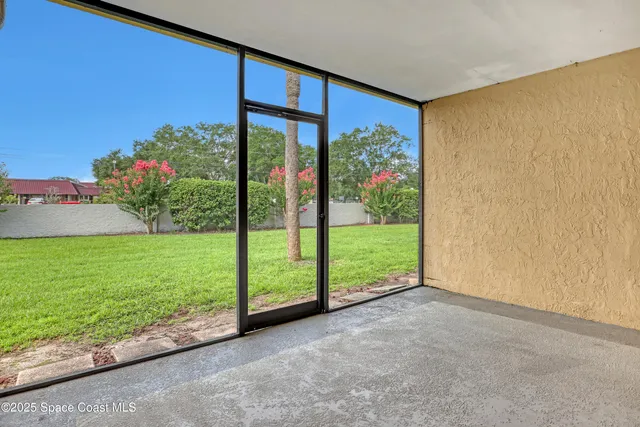 a view of a garden with a building in the background