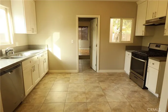 a kitchen with a stove a sink and a refrigerator