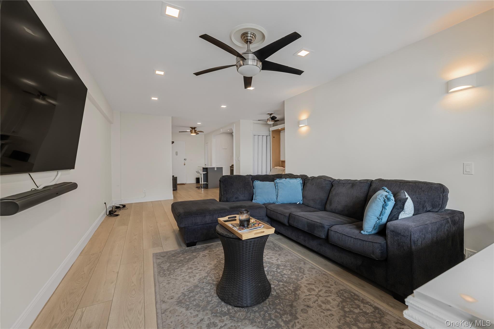 640 Pelham Road, Unit 3L New Rochelle, NY 10805 - Photo 8 of 20 a living room with furniture and a flat screen tv