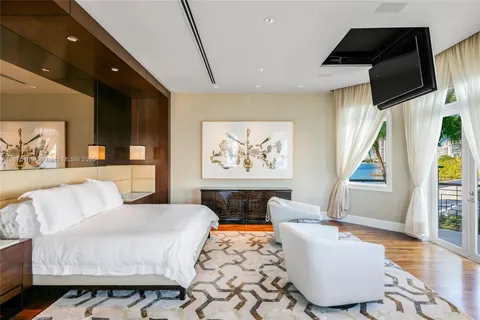 a living room with furniture a flat screen tv and kitchen view