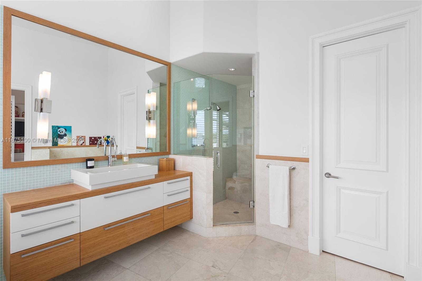 4042 Island Estates Drive Aventura, FL 33160 - Photo 27 of 46 a spacious bathroom with a double vanity sink and a mirror