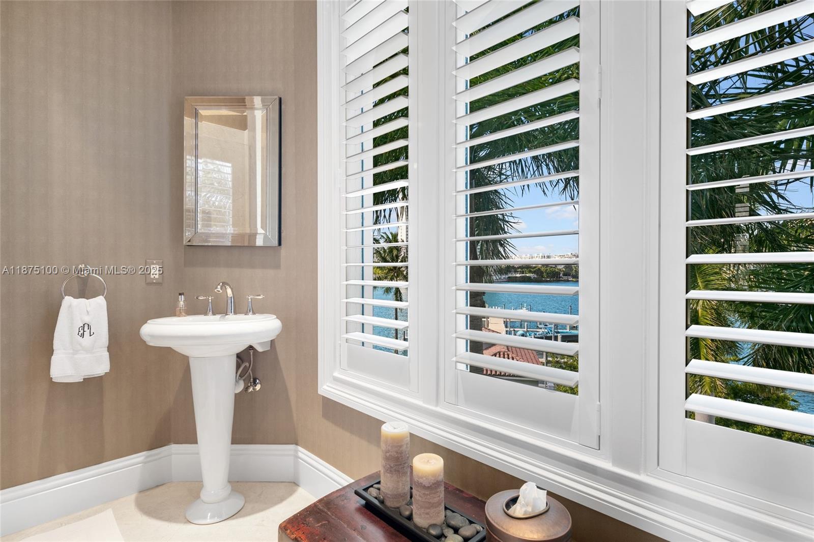 4042 Island Estates Drive Aventura, FL 33160 - Photo 28 of 46 a bathroom with a sink and a mirror