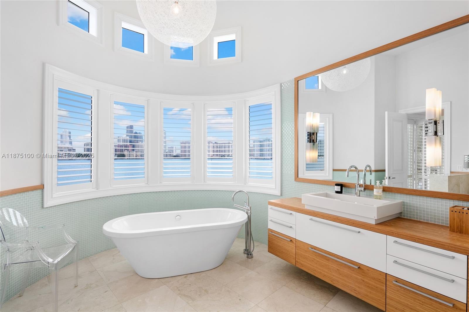 4042 Island Estates Drive Aventura, FL 33160 - Photo 29 of 46 a bathroom with a large tub sink and mirror