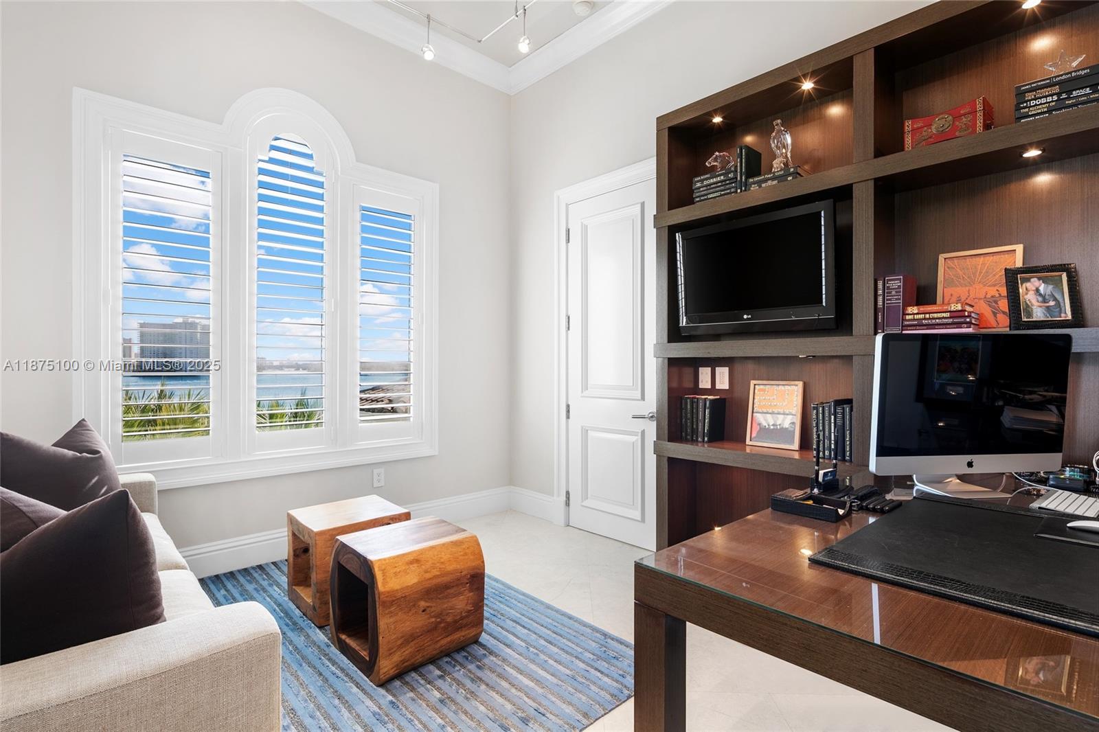 4042 Island Estates Drive Aventura, FL 33160 - Photo 31 of 46 a living room with furniture a flat screen tv and kitchen view