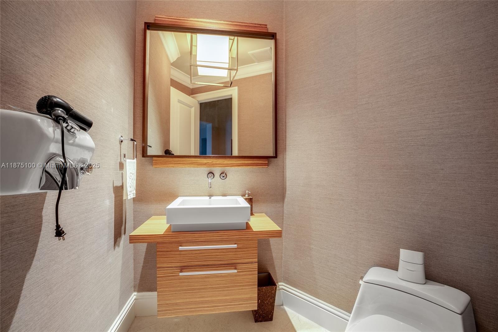 4042 Island Estates Drive Aventura, FL 33160 - Photo 34 of 46 a bathroom with a sink a toilet and mirror