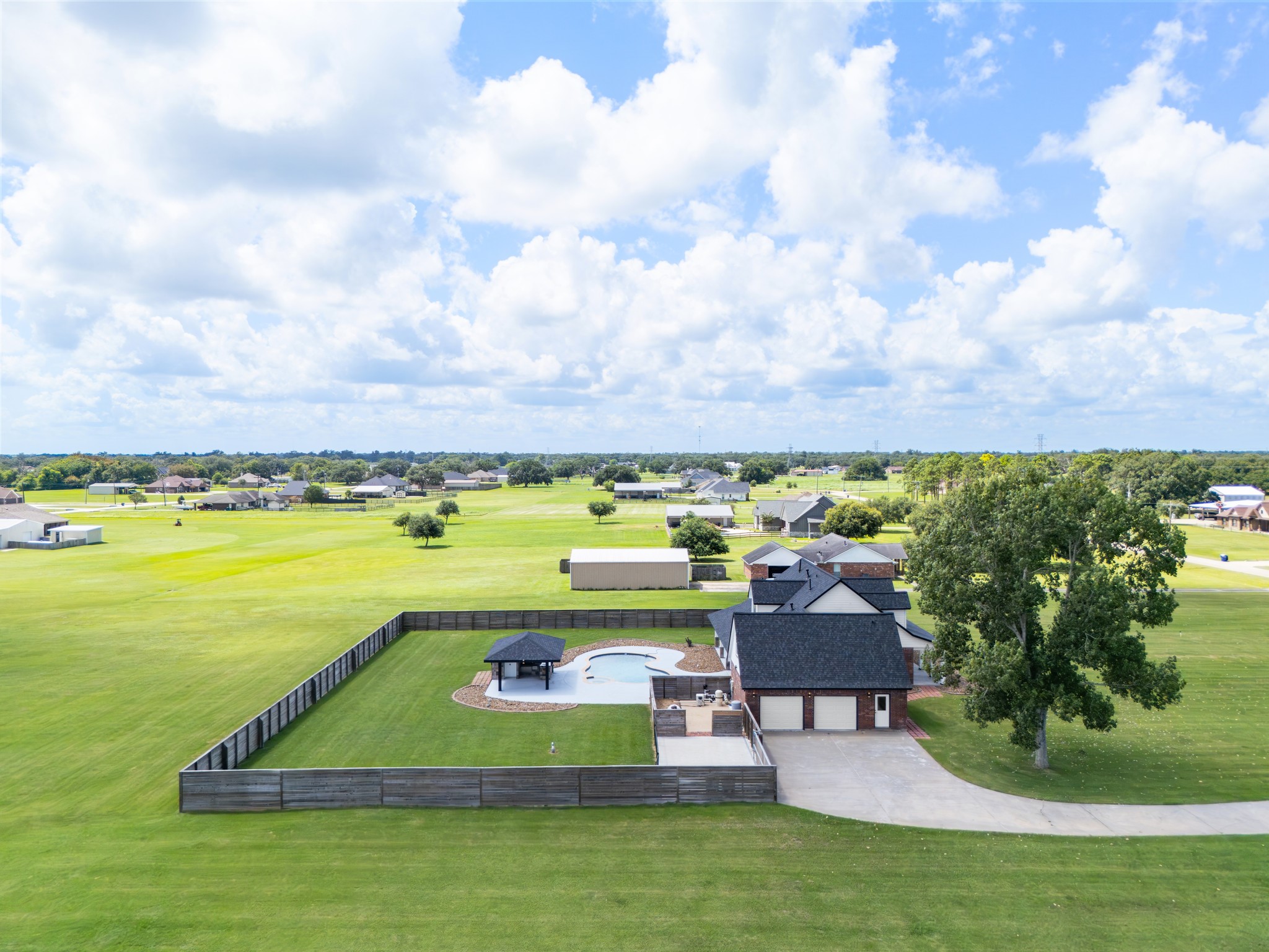 863 Bunkhouse Trail Angleton, TX 77515 - Photo 40 of 42 The whole place from above: pool, fenced yard, and 3.35 acres