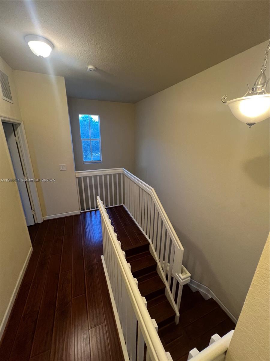 9217 Southwest 227th Street, Unit 11 Cutler Bay, FL 33190 - Photo 6 of 11 a view of entryway with wooden floor