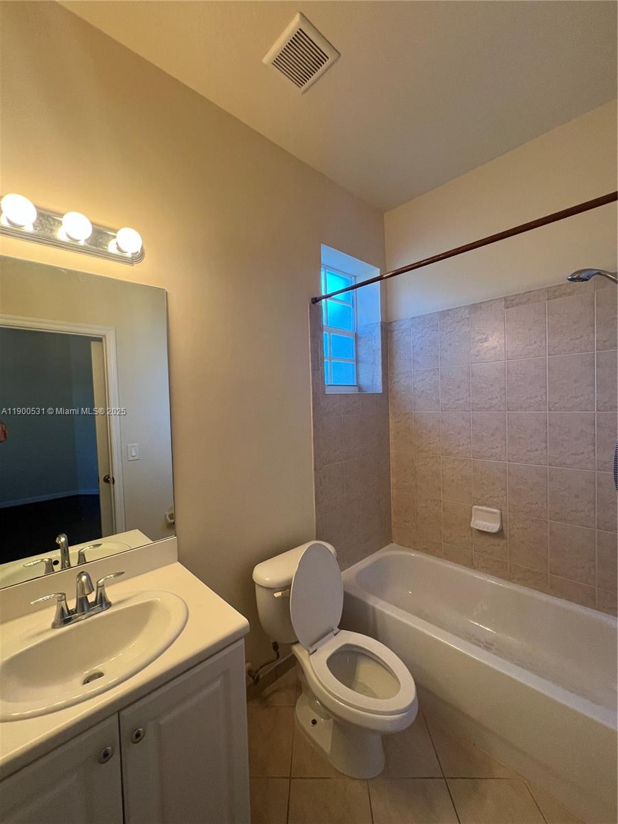 9217 Southwest 227th Street, Unit 11 Cutler Bay, FL 33190 - Photo 9 of 11 a bathroom with a sink a toilet and bathtub
