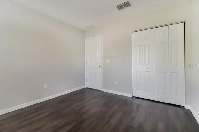 a bathroom with a granite countertop toilet a sink and a bathtub