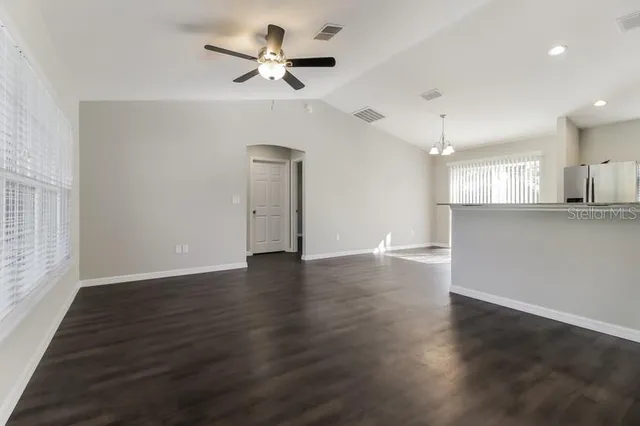 a kitchen with granite countertop a stove top oven microwave and cabinets