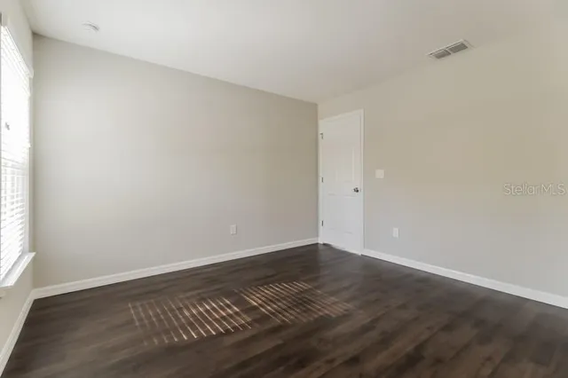 a bathroom with a granite countertop toilet and a sink