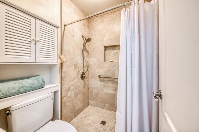 a bathroom with a shower and a sink