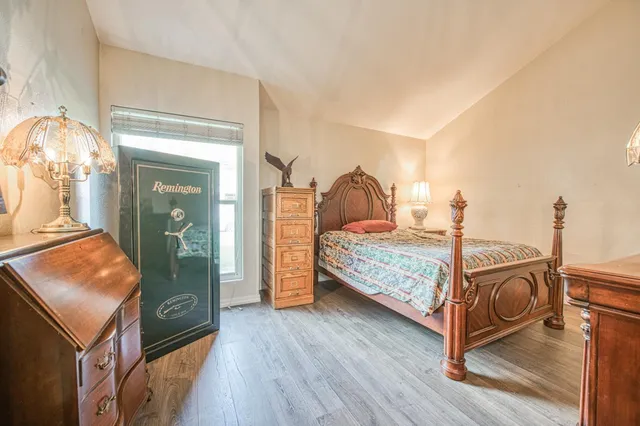 a bedroom with a bed and wooden floor