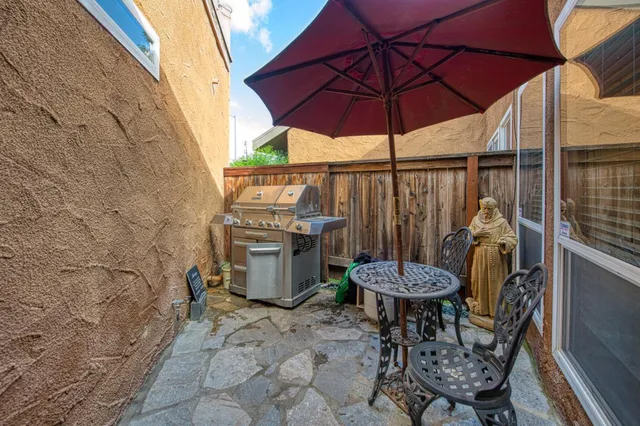 a view of a chairs and table in the patio