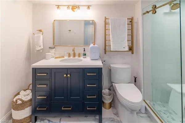 a bathroom with a toilet a sink and a mirror