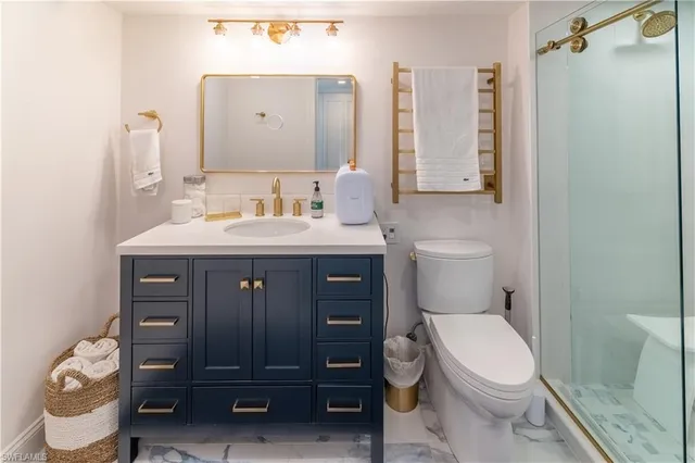 a bathroom with a toilet a sink and a mirror