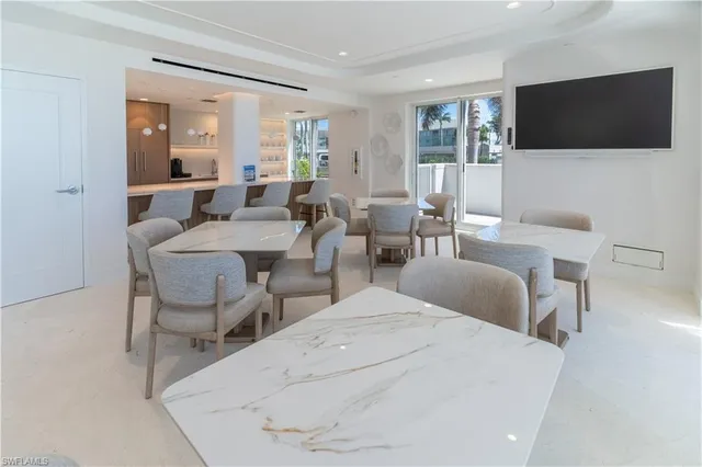 a living room with furniture a flat screen tv and large window