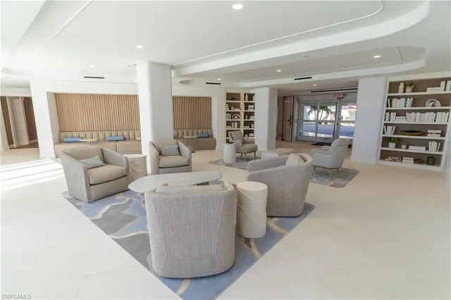 a living room with furniture and a bookshelf