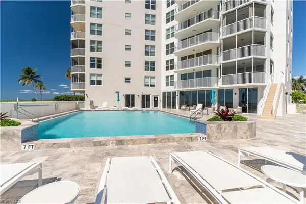 a view of building with a swimming pool