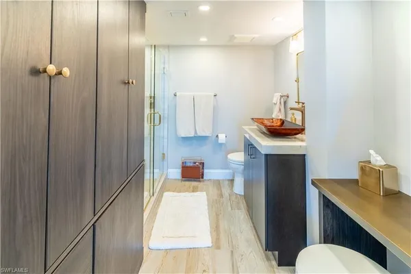 a bathroom with a sink a toilet and shower