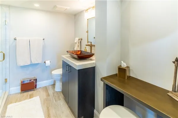 a bathroom with a sink a toilet and mirror