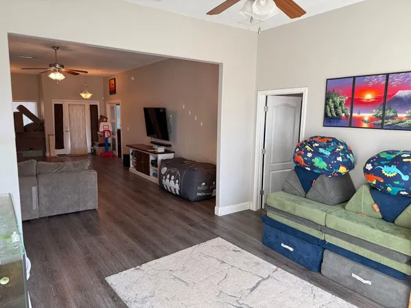 a living room with furniture and a flat screen tv