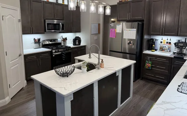 a kitchen with a sink a stove and refrigerator