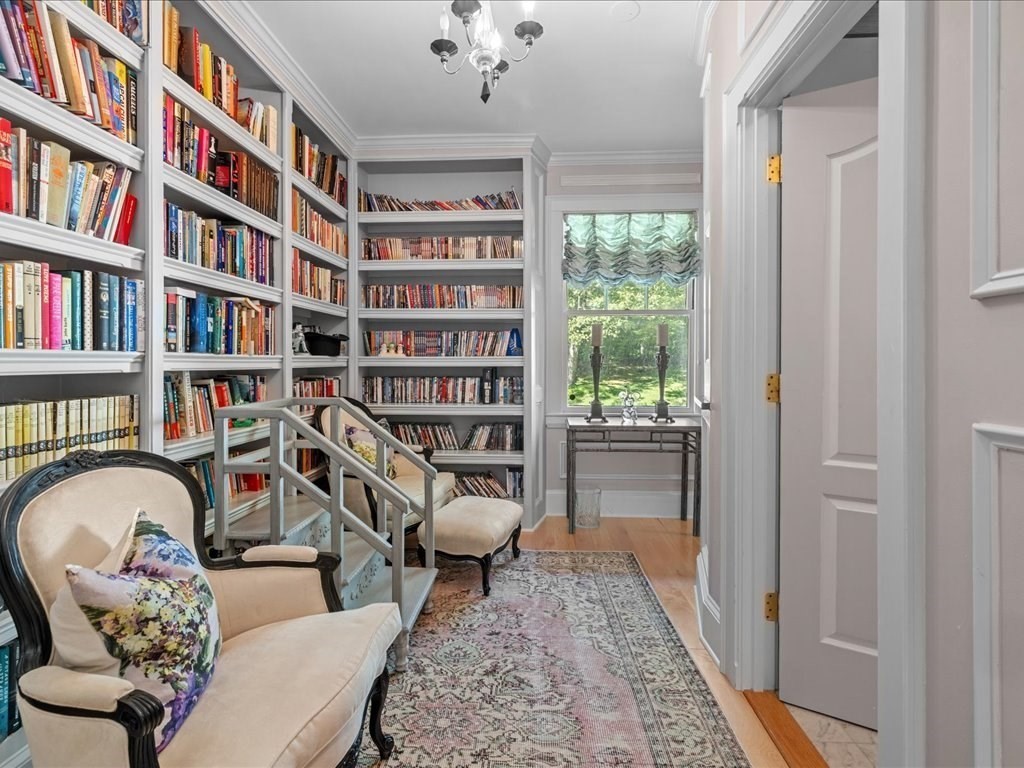142 Crafts Road Brookline, MA 02467 - Photo 27 of 42 a living room with furniture and a book shelf