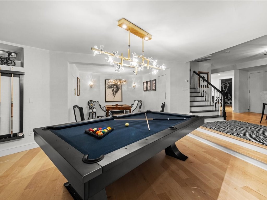 142 Crafts Road Brookline, MA 02467 - Photo 30 of 42 a living room with furniture a chandelier and a table