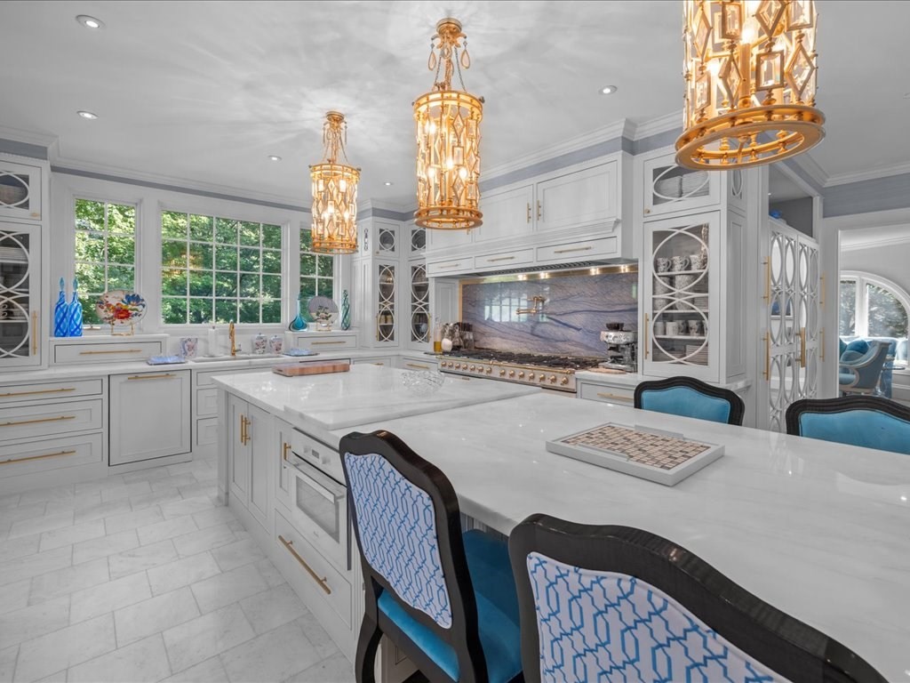 142 Crafts Road Brookline, MA 02467 - Photo 4 of 42 a kitchen with a stove a sink a chandelier dining table and chairs