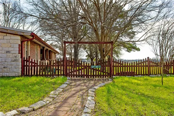 a view of a house with a small yard and fence