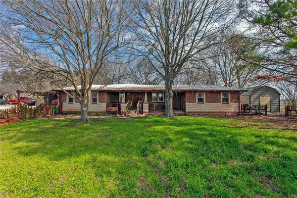 a front view of a house with yard patio and green space