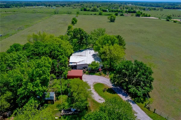 an aerial view of a house with a yard and lake view